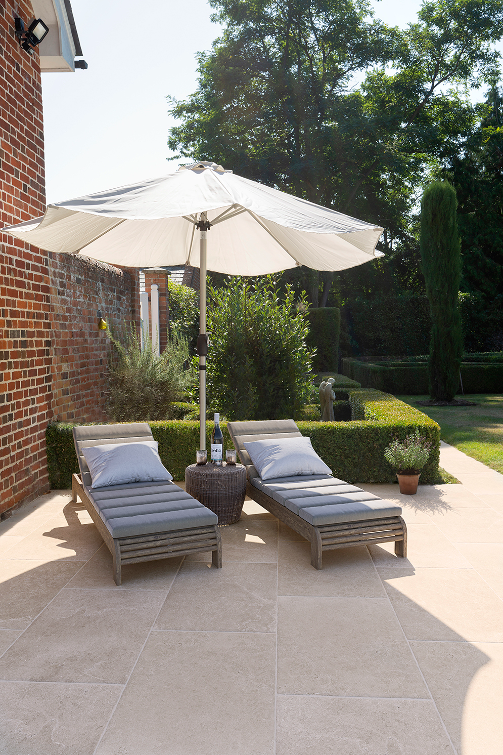 Garden patio using Hambleton beige pavers with sun loungers