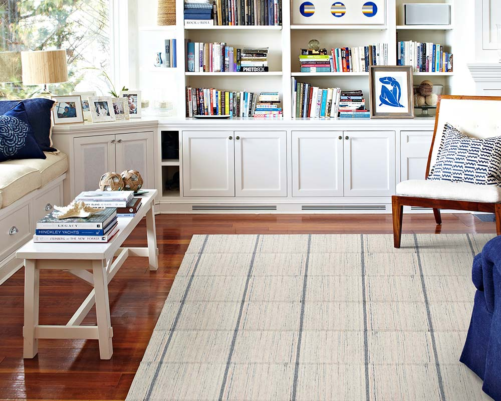 Custom area rug in a den with blue accents