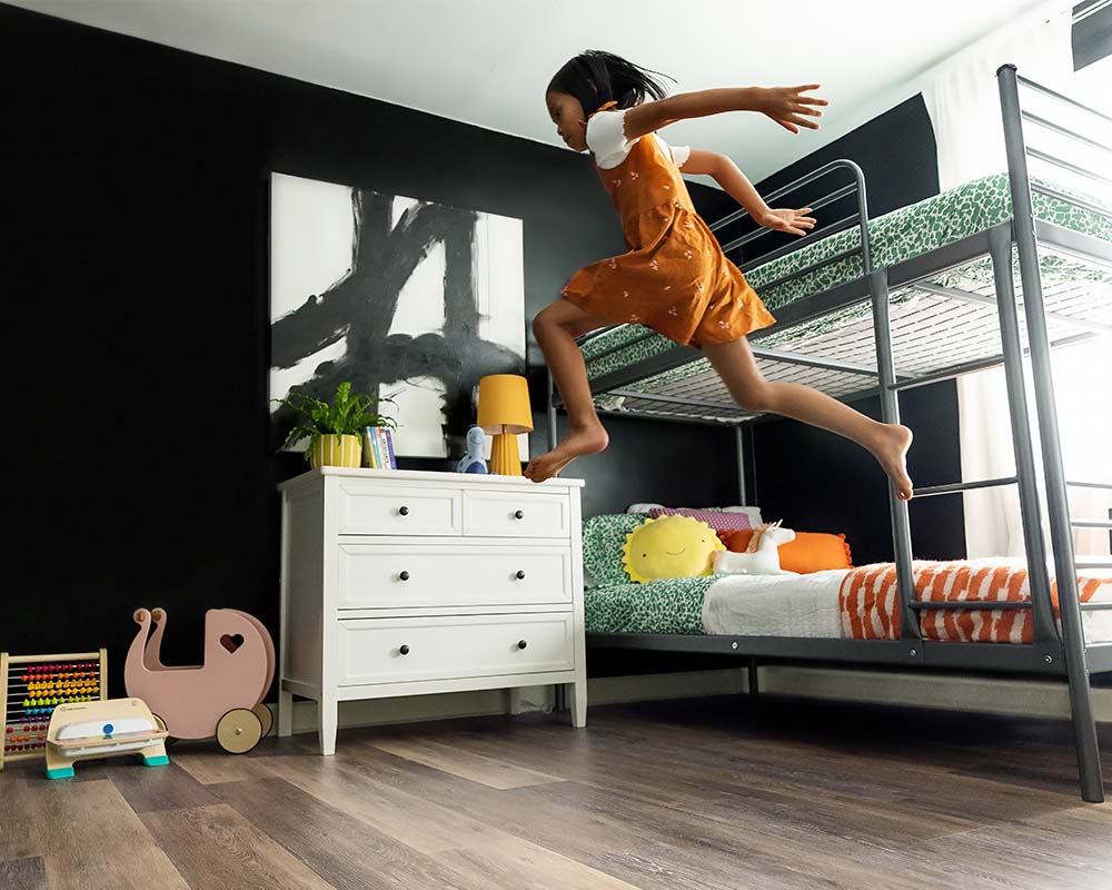 Girl jumping from a bunkbed onto the floor