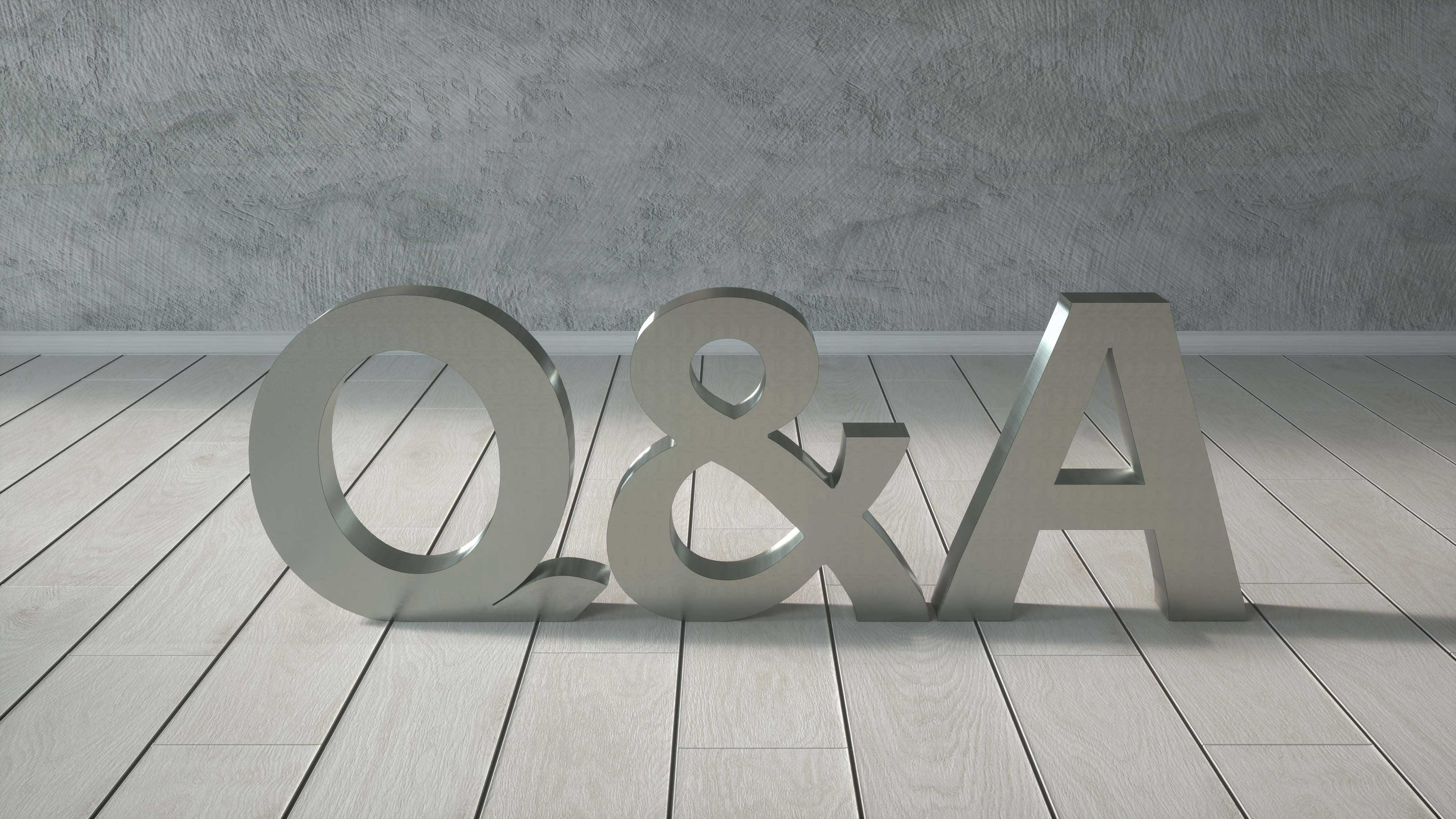 Q & A cut out letters in silver on a light colored floor.