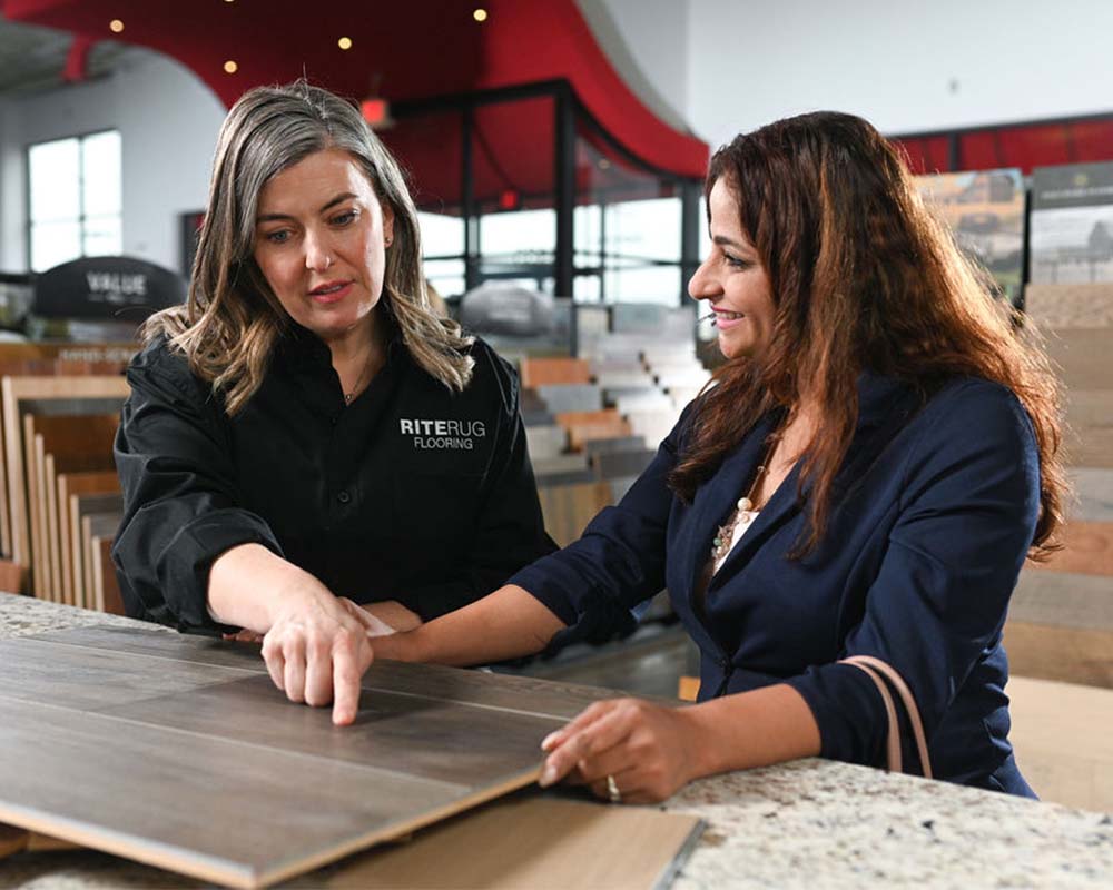 Flooring customer and sales expert reviewing flooring samples