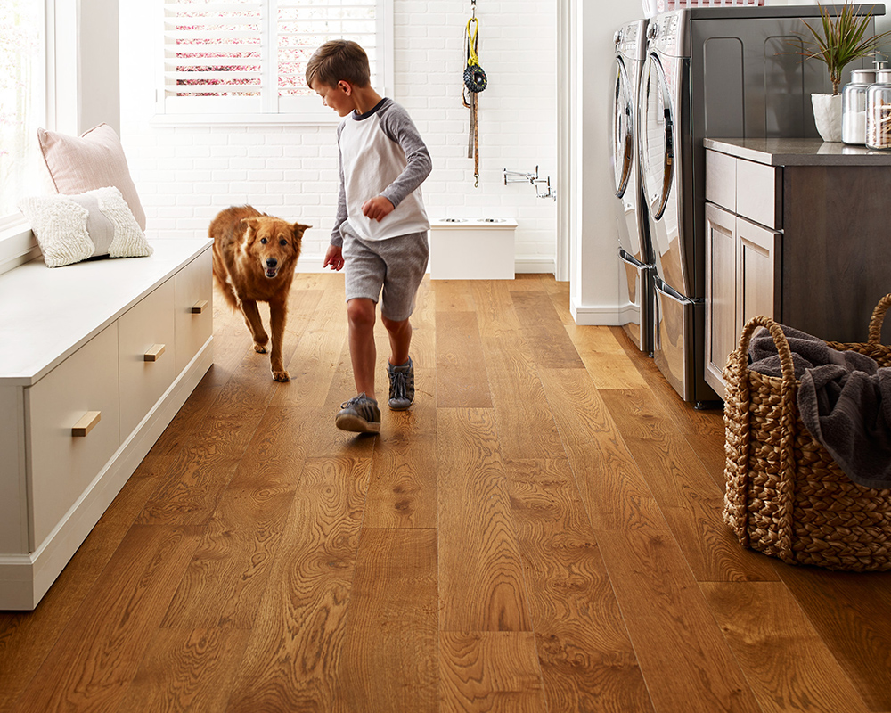 Boy running in the house with his dog