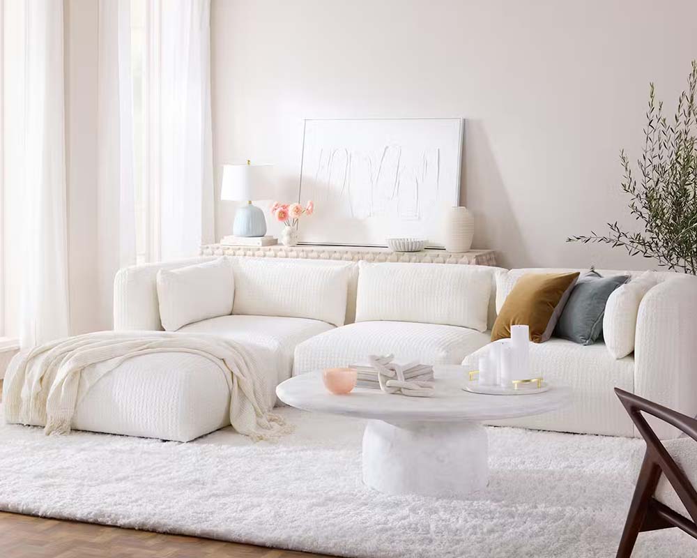 Room with large white couch, walls painted with Cloud Dancer