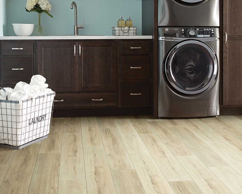 Laundry room with basket, washer and dryer and luxury vinyl flooring