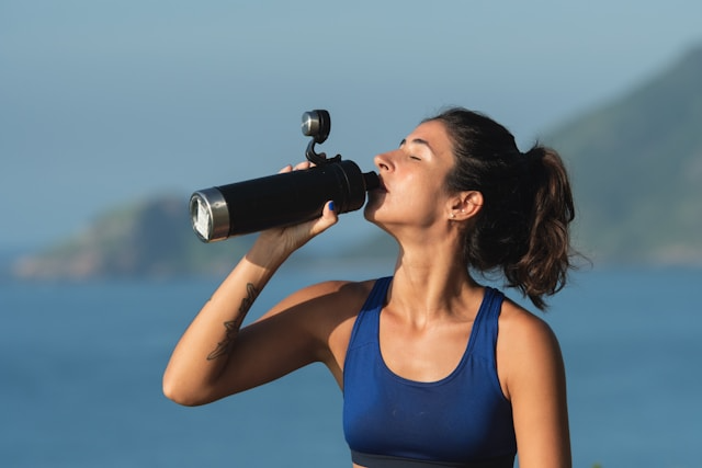 A packet of sugar-free electrolytes powder being poured into a glass of water, creating a refreshing splash.