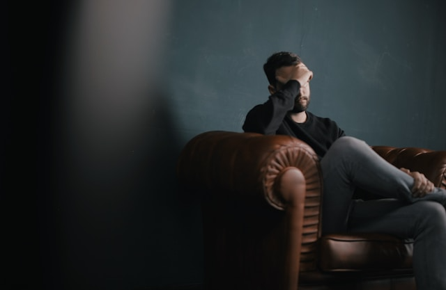 A person looking tired and thoughtful, considering their health.