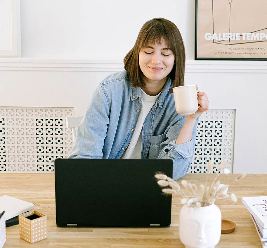 A satisfied woman working at her computer.