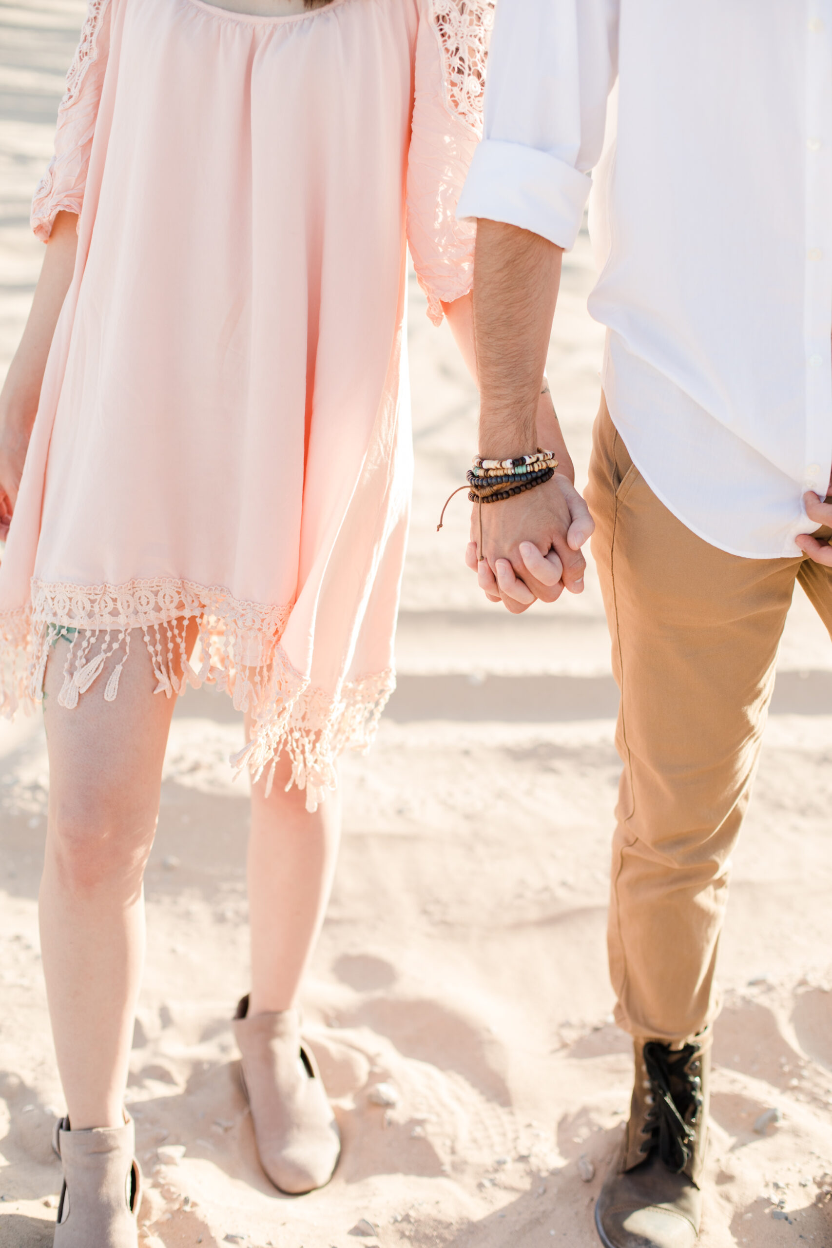 couple holding hands in the sand, do you need a permit to shoot in a national park